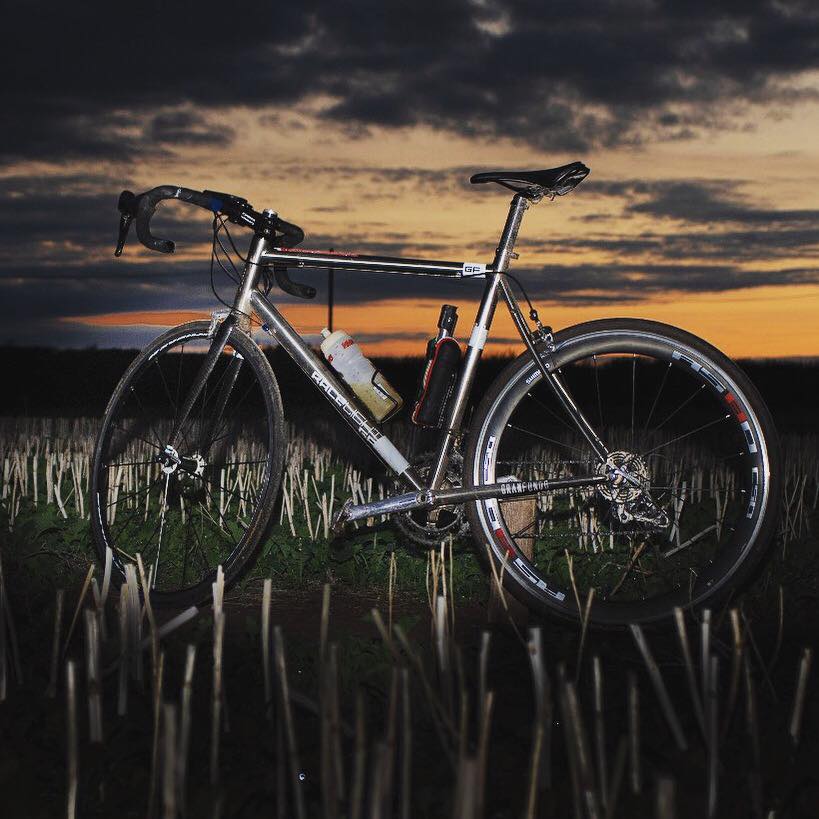 Photograph of Richi's bike infront of a sunset before the 200 mile ride