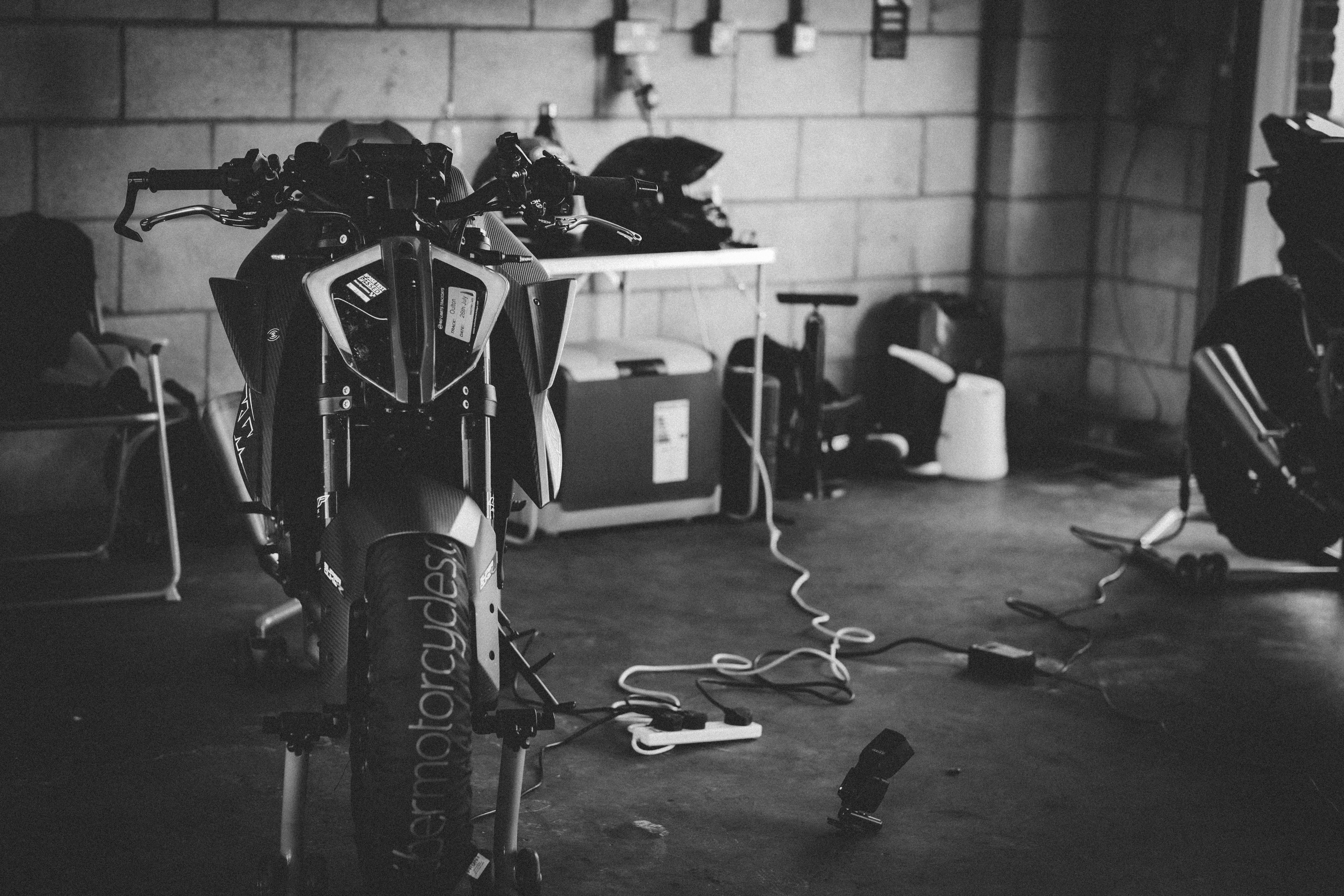 Motorbike KTM in the pits at Oulton Park, black and white